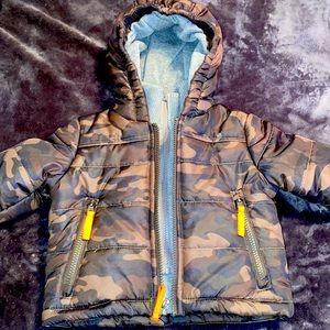 Camouflage puffer coat.